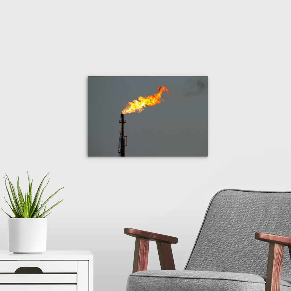 A modern room featuring Dutch Antilles, Aruba, Flames billow from natural gas flare at Valero Oil Refinery | Location: Sa...