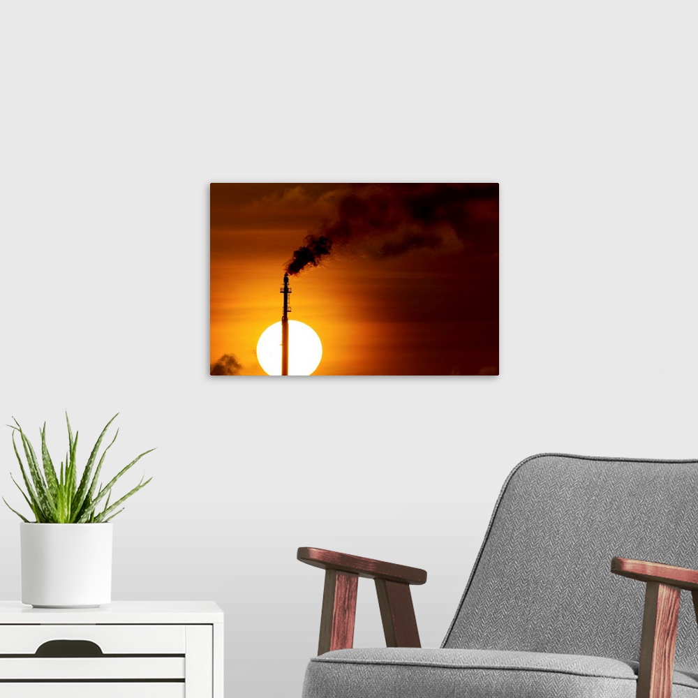 A modern room featuring Aruba, Flames billow from natural gas flare at Valero Oil Refinery at sunset. | Location: San Nic...