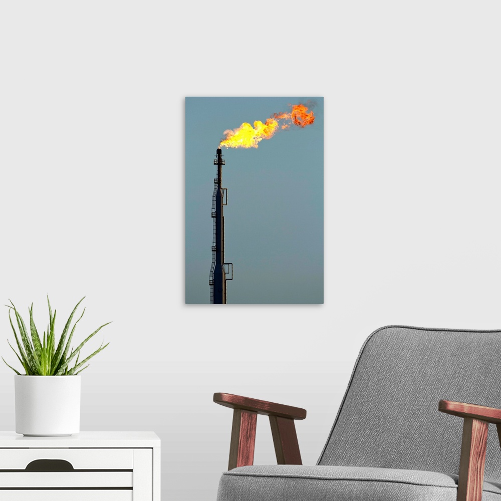 A modern room featuring Aruba, Flames billow from natural gas flare at Valero Oil Refinery. | Location: San Nicholas, Aruba.