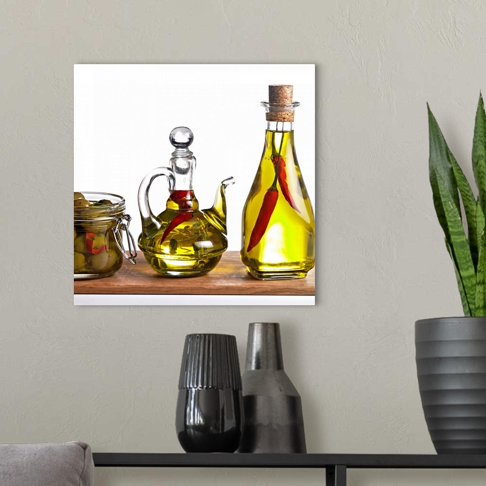 A modern room featuring Oil with chillies and olive against white background, close-up