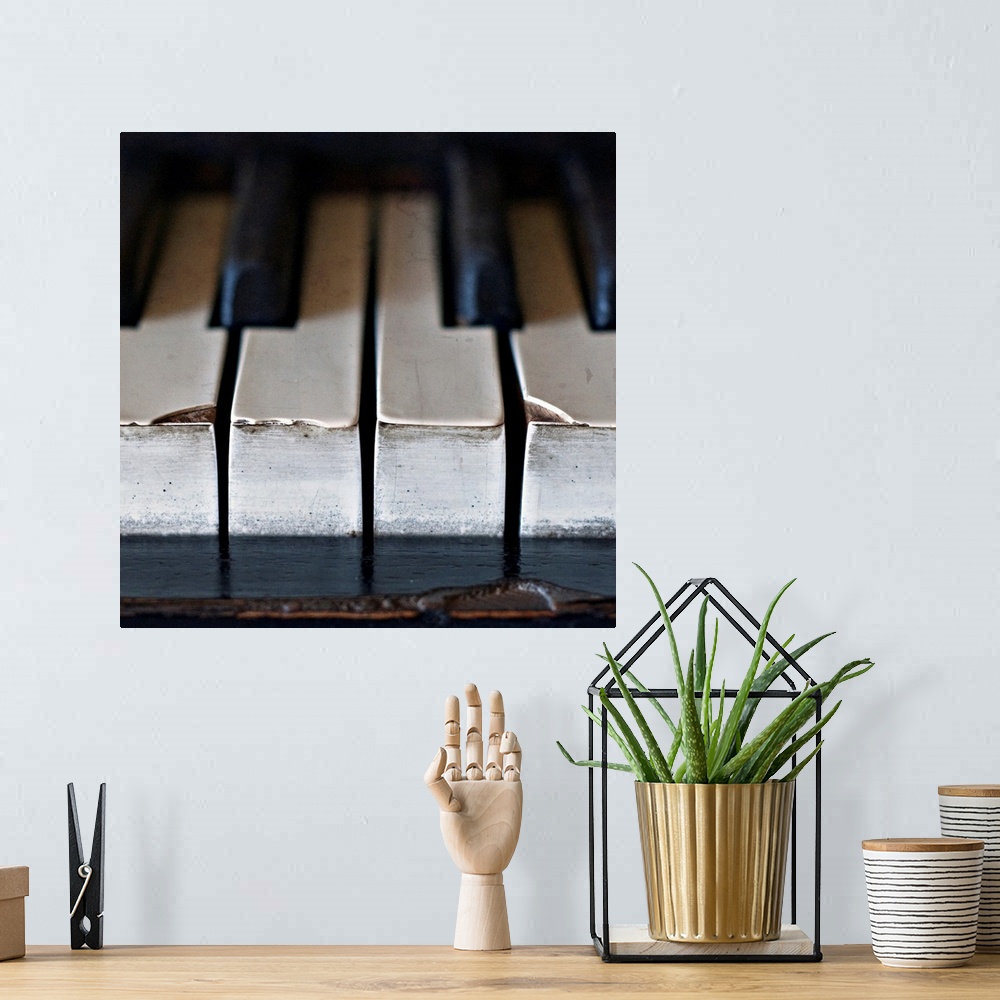 A bohemian room featuring Old, antique upright piano keys displaying wear and tear.