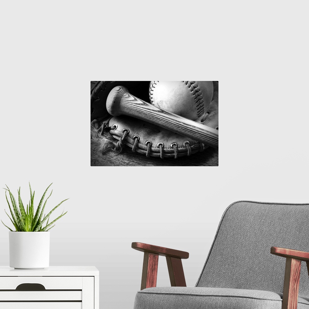 A modern room featuring A black and white image of an old baseball glove and bat.