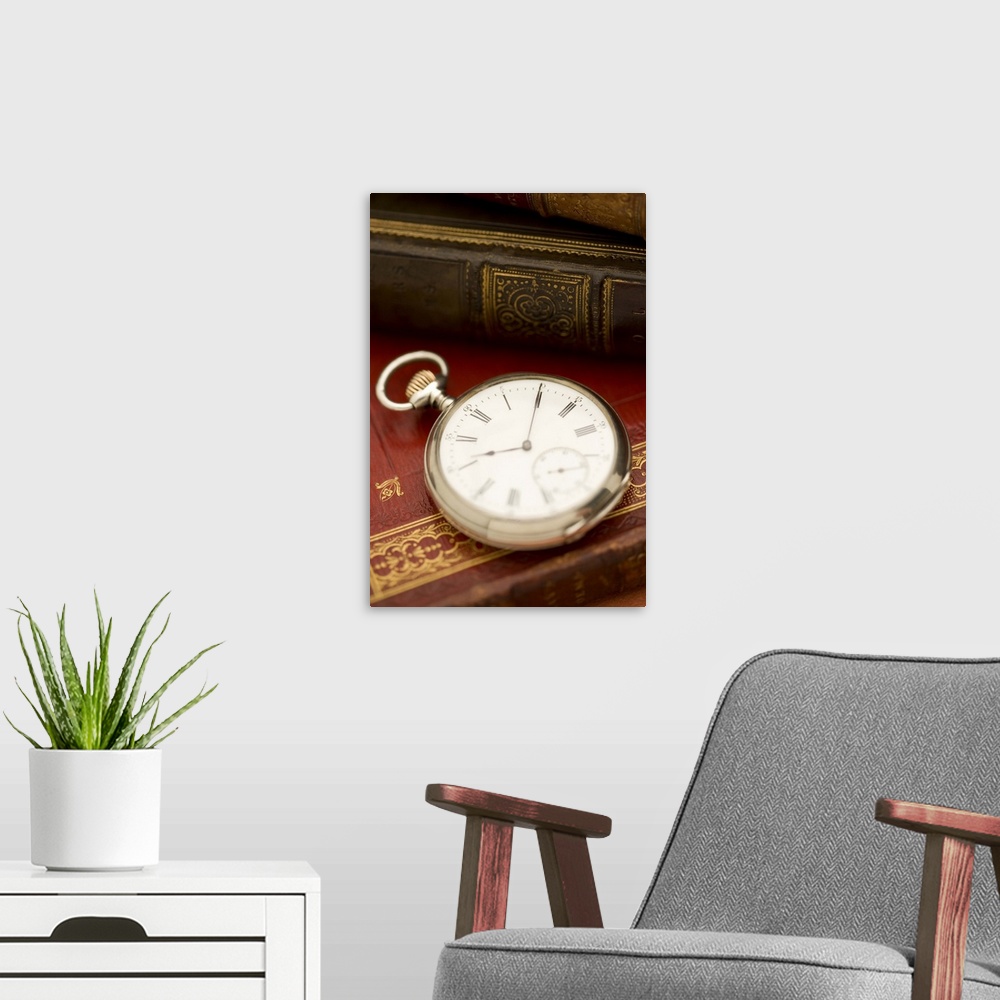A modern room featuring Old-fashioned pocket watch and books