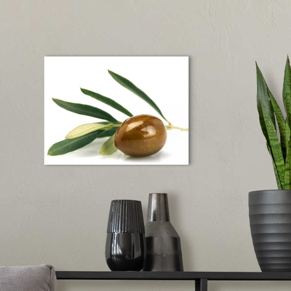 A modern room featuring Green olive with leaves shot on white background. Studio shot, horizontal frame.