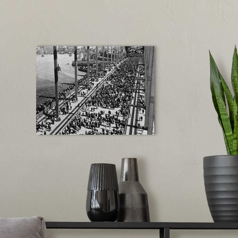 A modern room featuring Crowds crossing Sydney Harbour Bridge for the opening celebration.