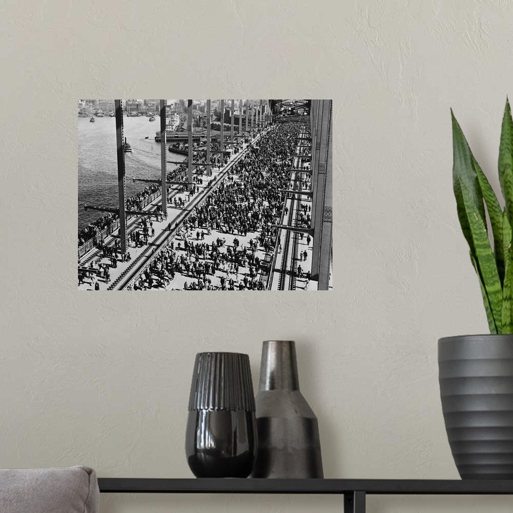 A modern room featuring Crowds crossing Sydney Harbour Bridge for the opening celebration.