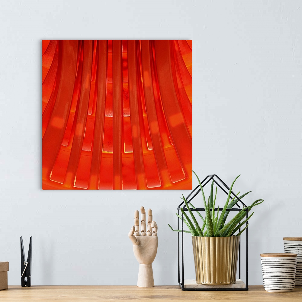 A bohemian room featuring Graphic sunny view of a geometrical pattern made of orange molded plastic.