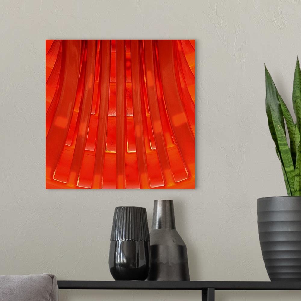 A modern room featuring Graphic sunny view of a geometrical pattern made of orange molded plastic.