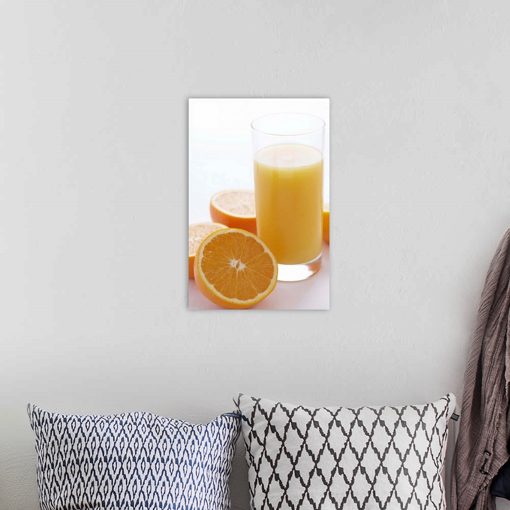 A bohemian room featuring Oranges by orange juice in glass, close-up