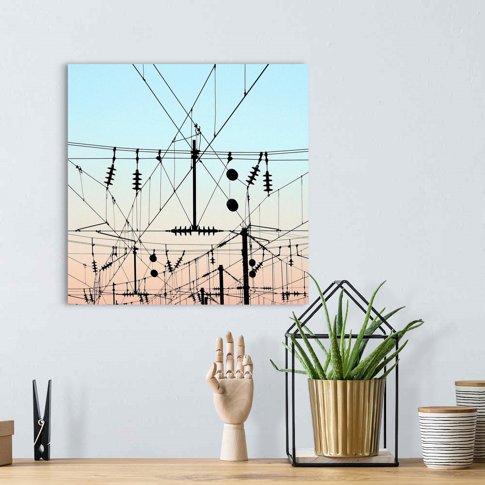 A bohemian room featuring Overhead lines station, train electricity wires with evening sky.