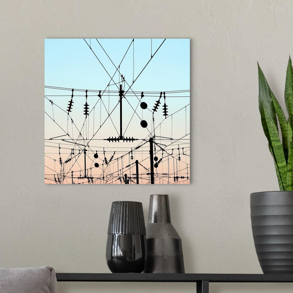 A modern room featuring Overhead lines station, train electricity wires with evening sky.