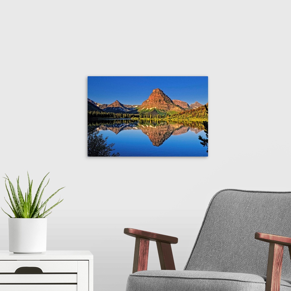 A modern room featuring An image from Glacier Park's Two Medicine area.Shown here is Painted Teepee mountain, stunning Mt...
