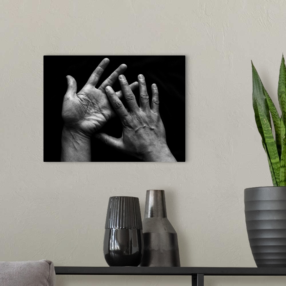 A modern room featuring Human pair of hands on black background.