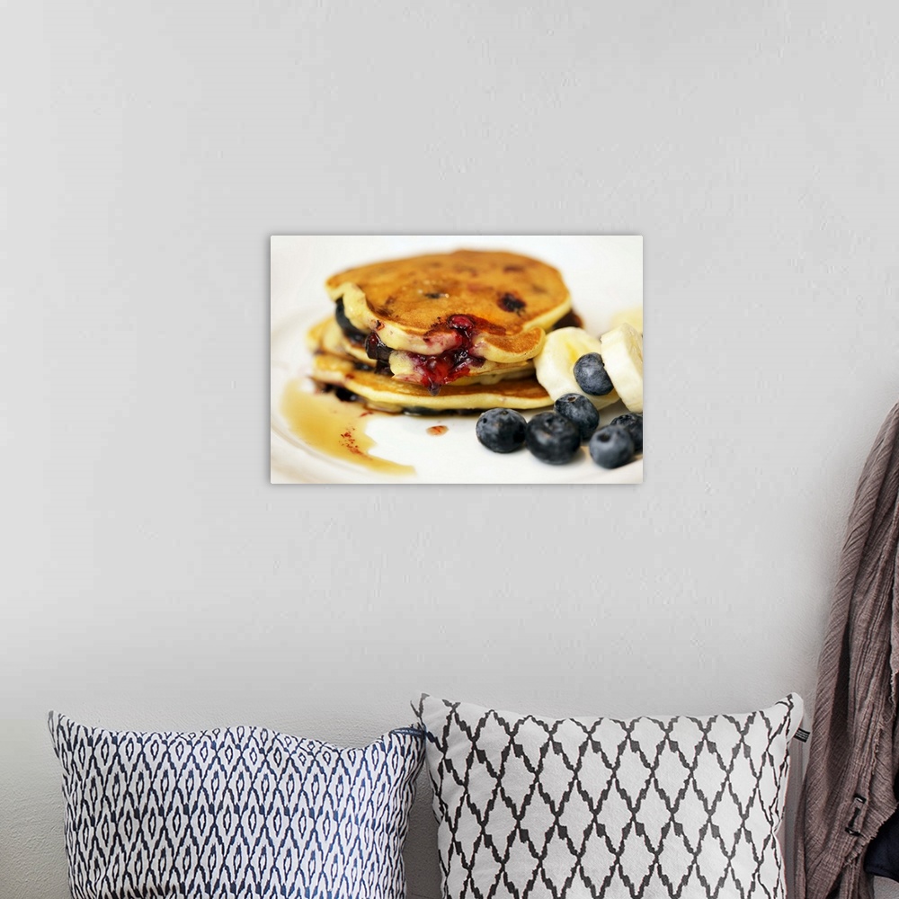 A bohemian room featuring Pancakes with blueberries, bananas and maple syrup