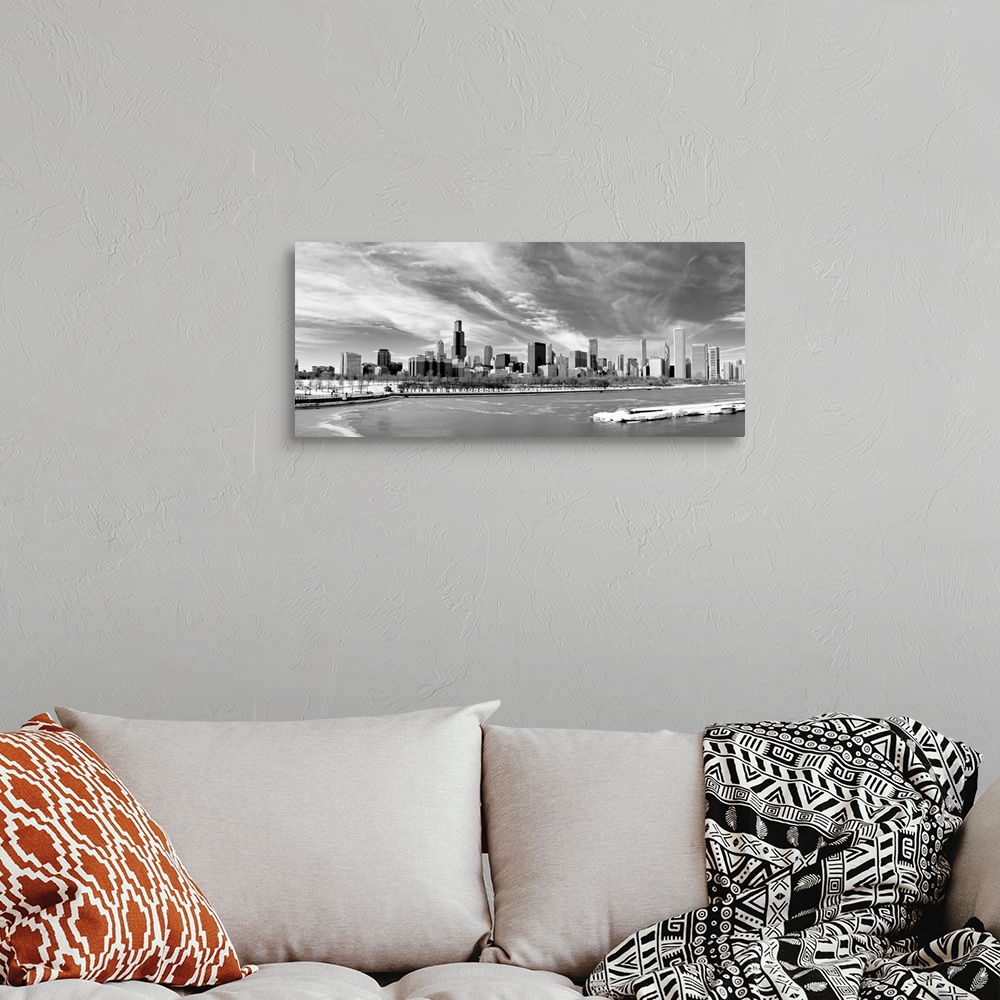 A bohemian room featuring Landscape photograph on a large canvas of the Chicago skyline during winter, beneath a sky of wis...