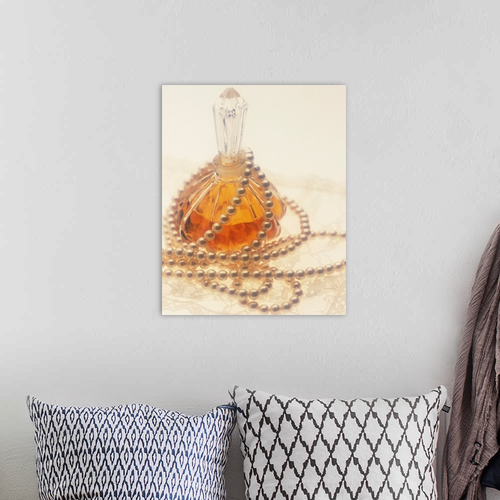 A bohemian room featuring Pearl necklace draped around a perfume bottle