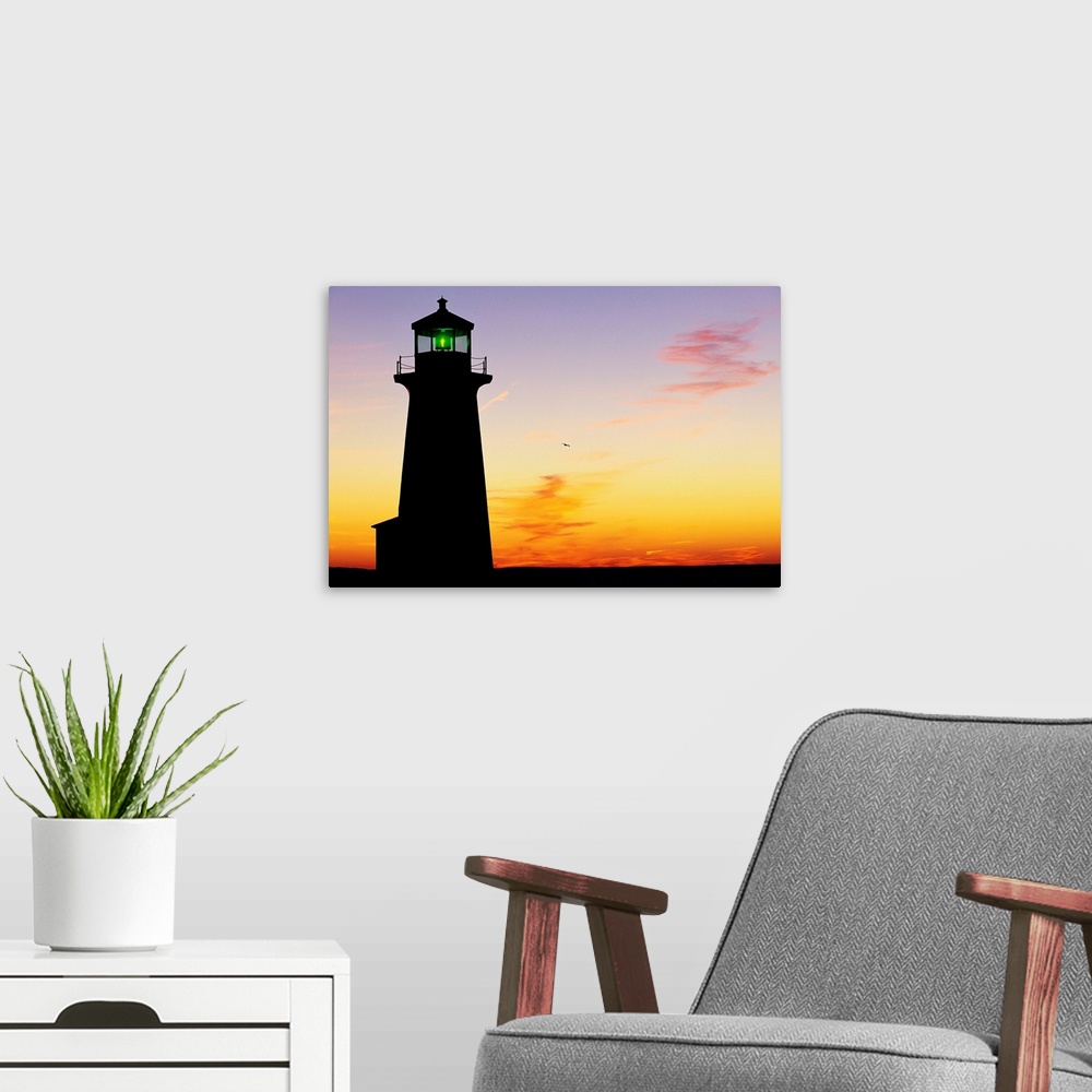 A modern room featuring Silhouette of Peggy's Cove Lighthouse at sunset in Nova Scotia.