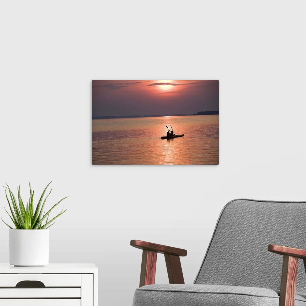 A modern room featuring People kayaking at sunset