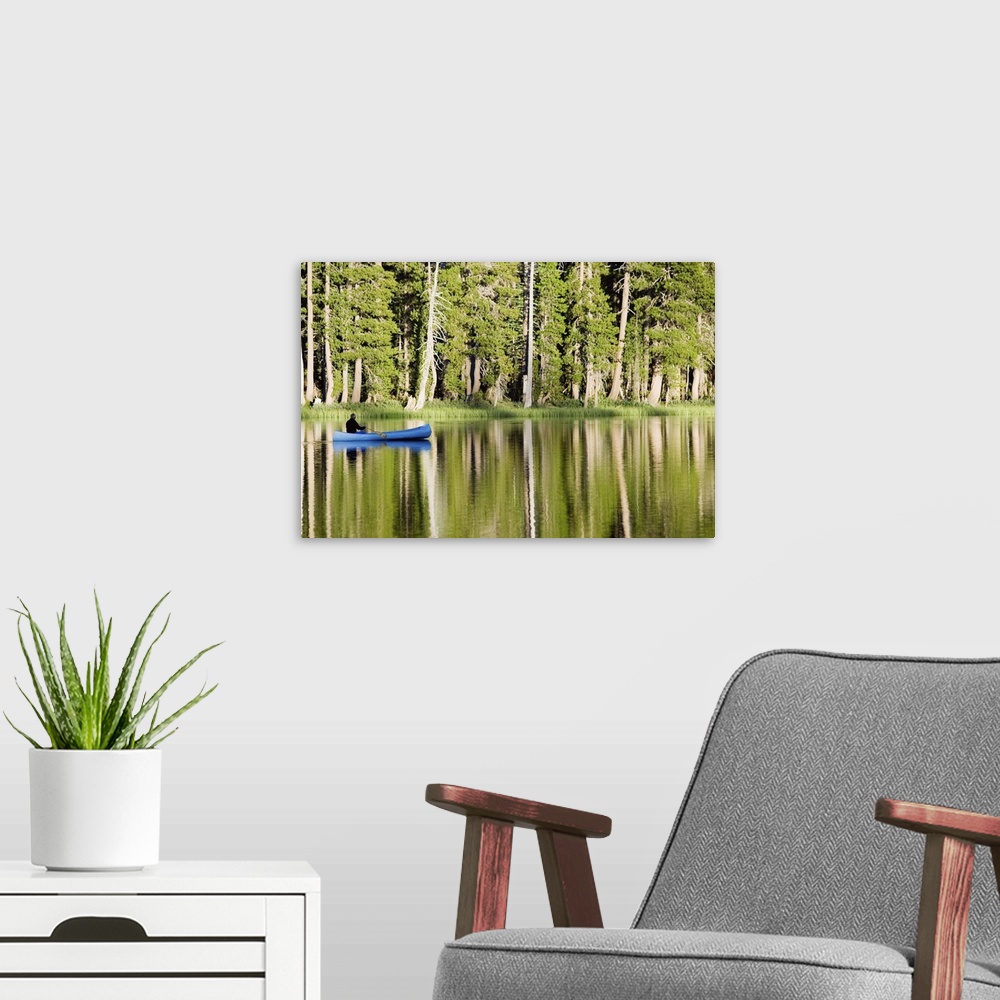 A modern room featuring Person in a boat on a lake