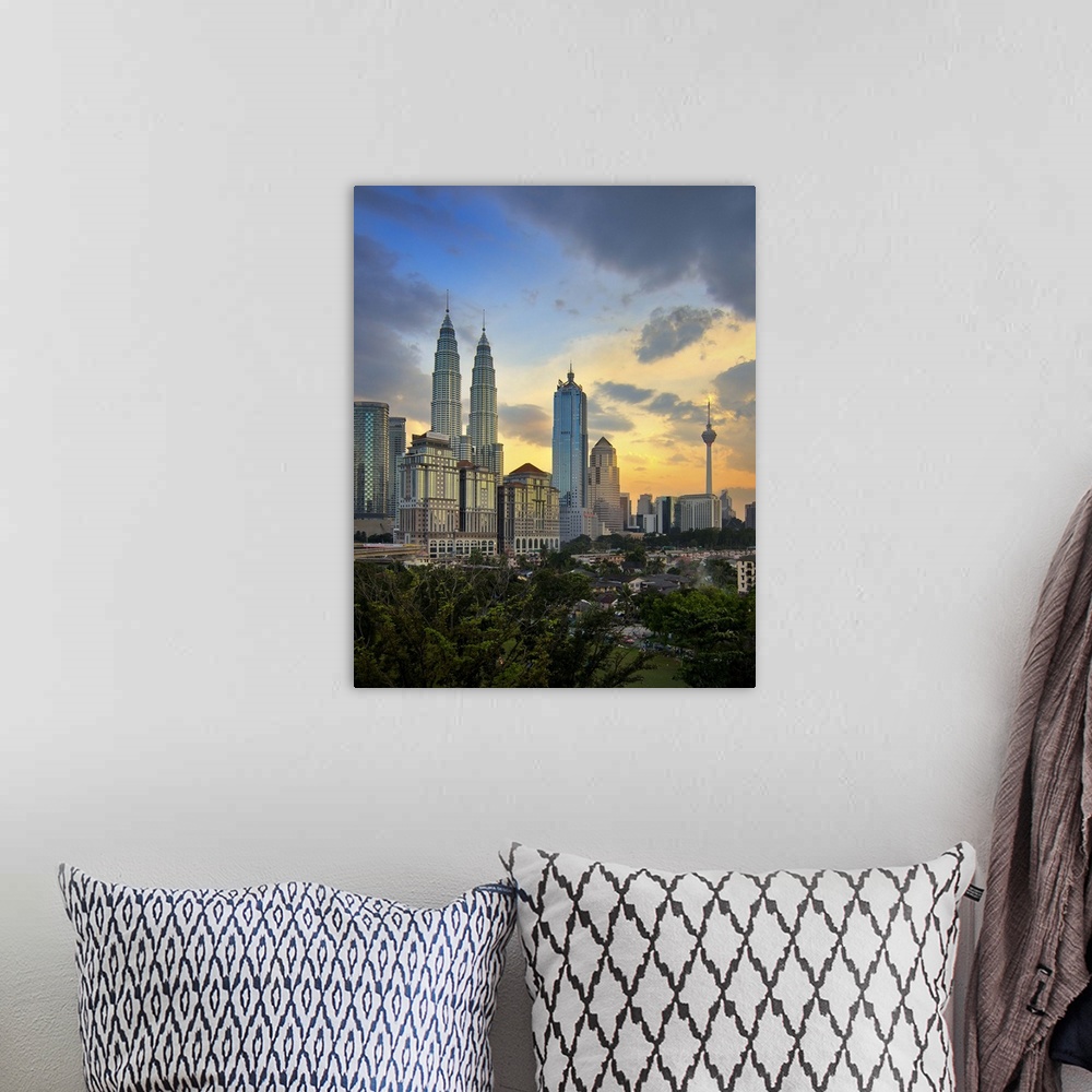 A bohemian room featuring Petronas twin towers at sunset.