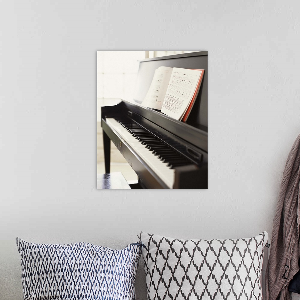 A bohemian room featuring Piano with sheet music