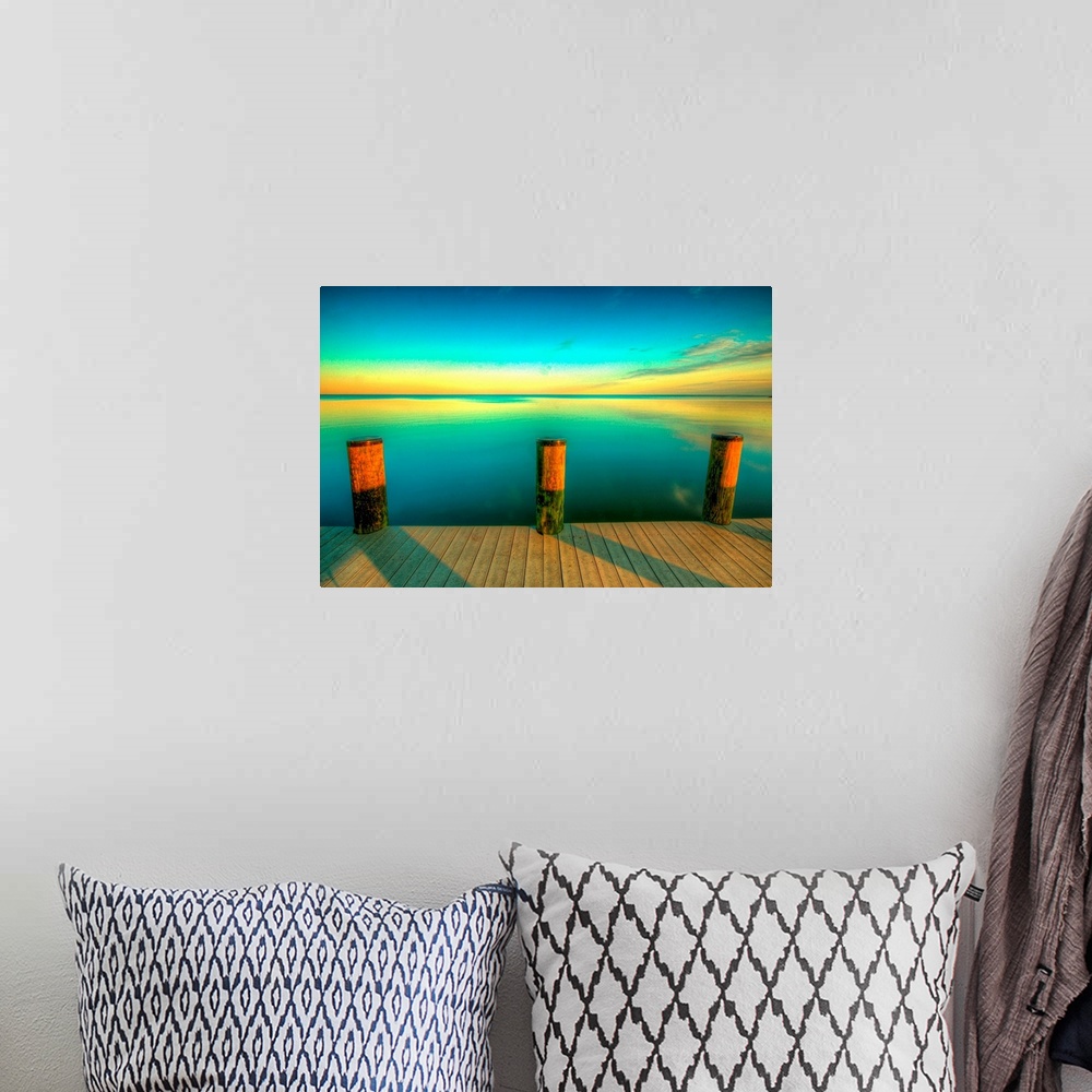 A bohemian room featuring Big canvas photo art of a dock looking off onto calm water at sunset with the sky colors reflecti...