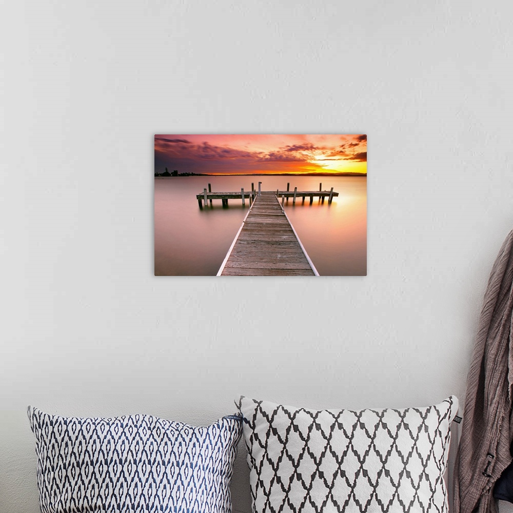 A bohemian room featuring Photograph of pier stretching into the ocean at dusk.  The sky is colorful from the setting sun a...