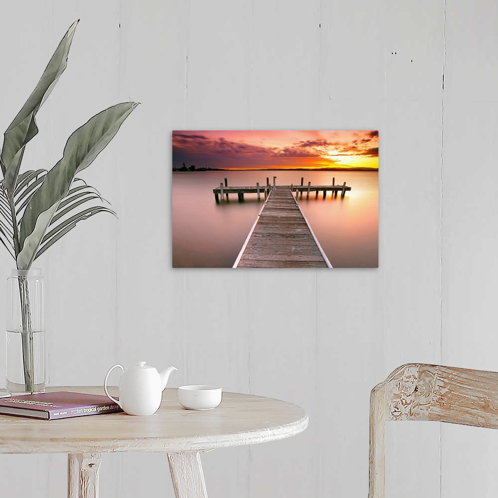 A farmhouse room featuring Photograph of pier stretching into the ocean at dusk.  The sky is colorful from the setting sun a...