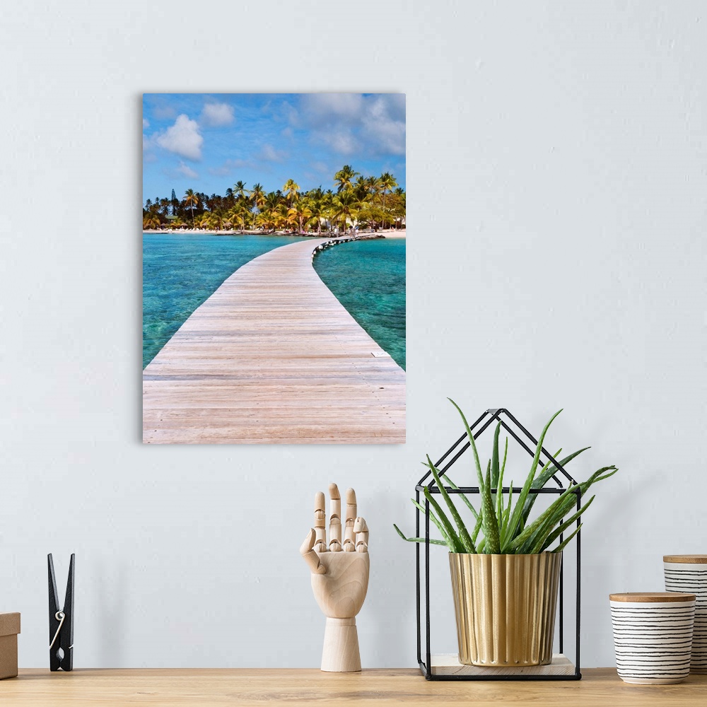 A bohemian room featuring Vertical photograph on a big canvas of a wooden path over clear blue waters, leading toward a tro...