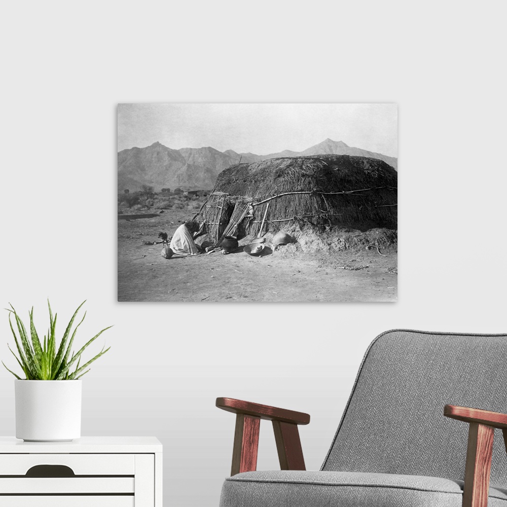 A modern room featuring A photograph of a Pima round dwelling, or ki, published in a portfolio supplementing Volume II of...