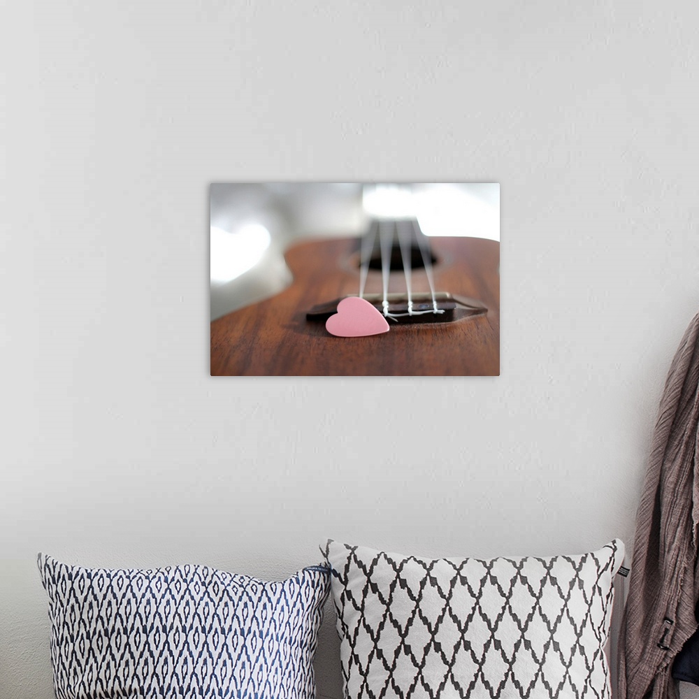 A bohemian room featuring Pink heart on guitar.