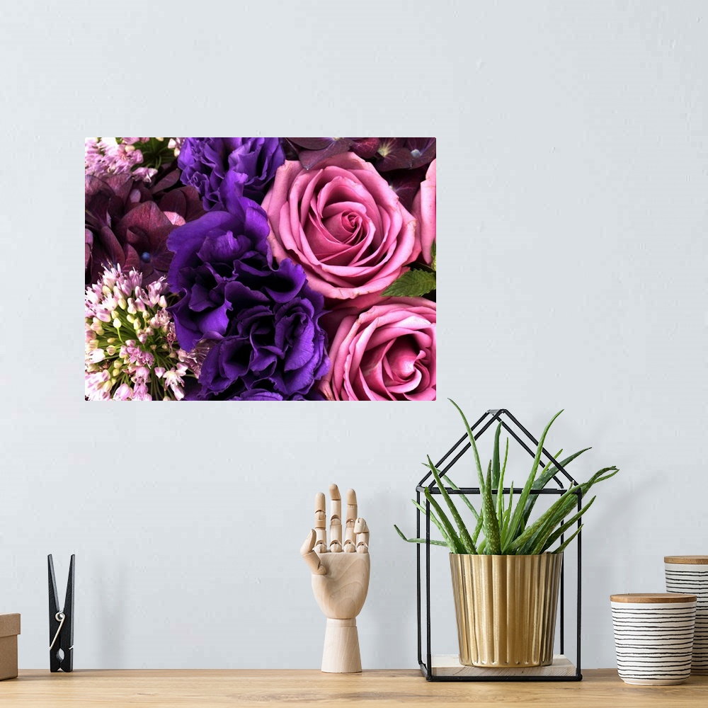 A bohemian room featuring Big canvas photo of different multicolored flowers arranged together.