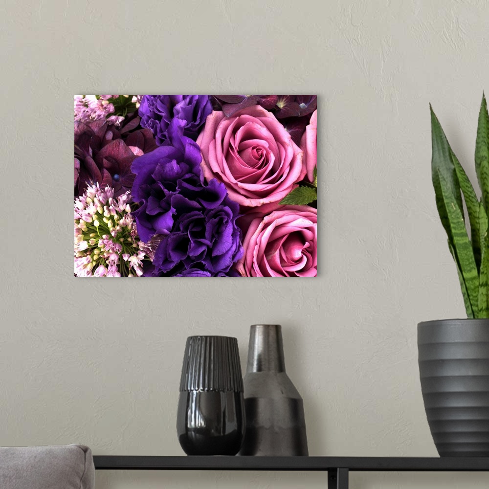 A modern room featuring Big canvas photo of different multicolored flowers arranged together.
