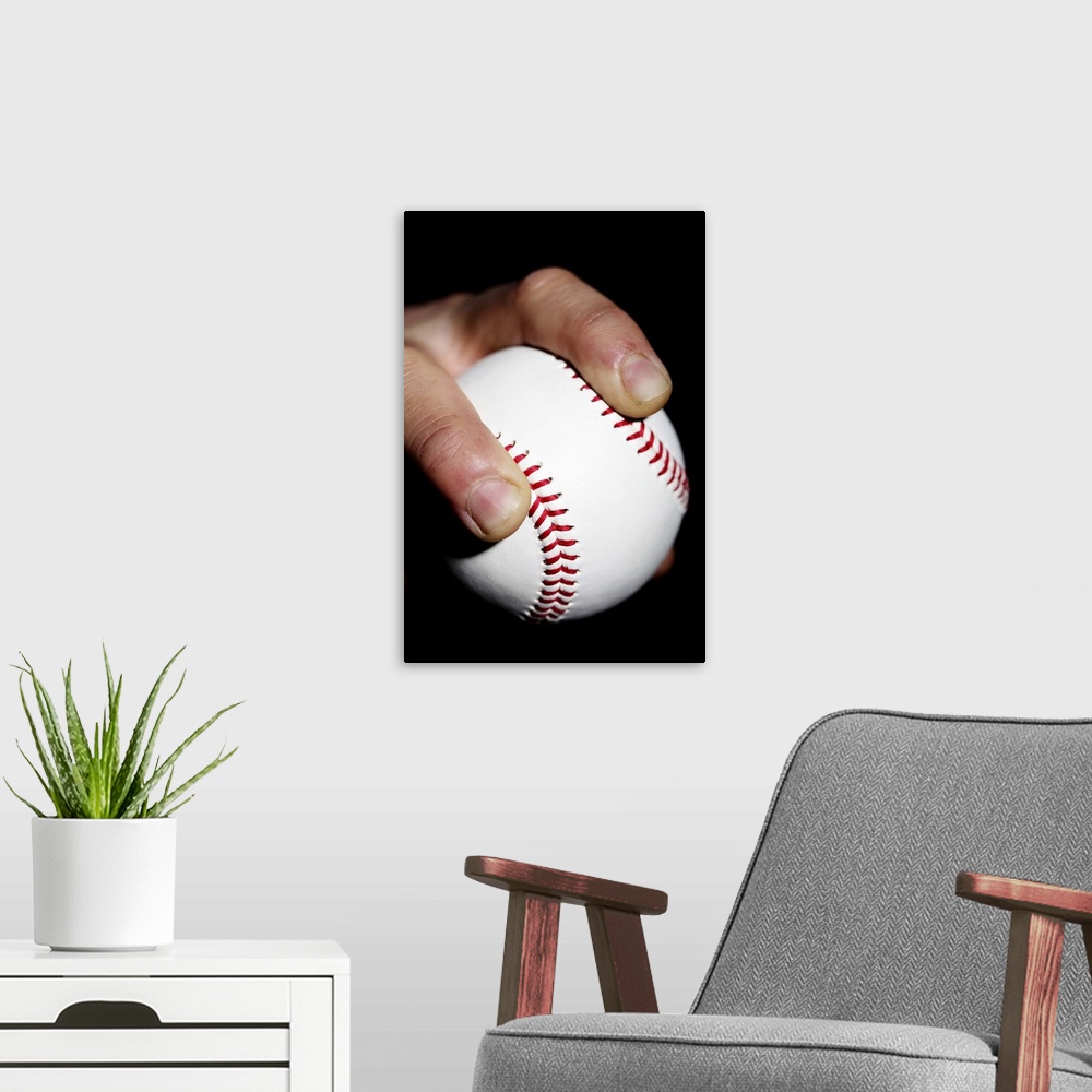 A modern room featuring Pitchers hand gripping a baseball