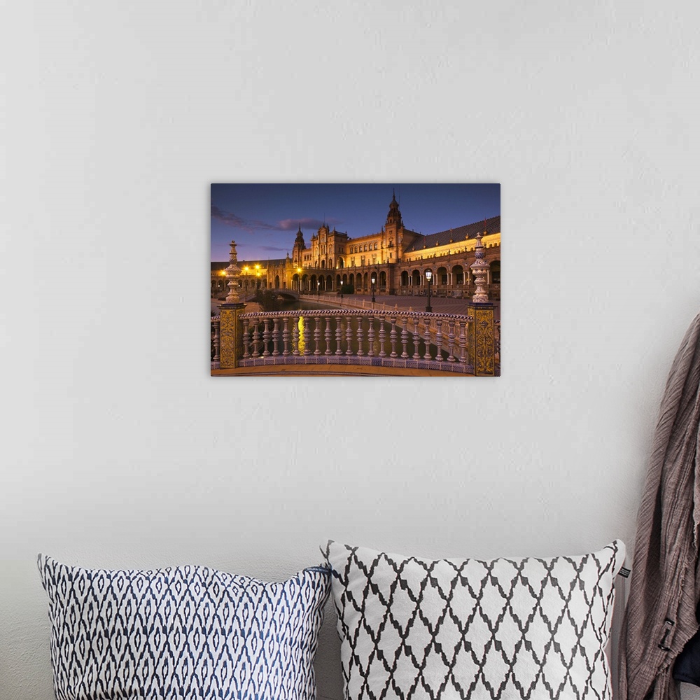 A bohemian room featuring Spain, Andalucia Region, Seville Province, Seville, Plaza de Espana buildings, evening