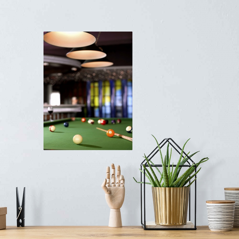 A bohemian room featuring Pool table and glass of wine.