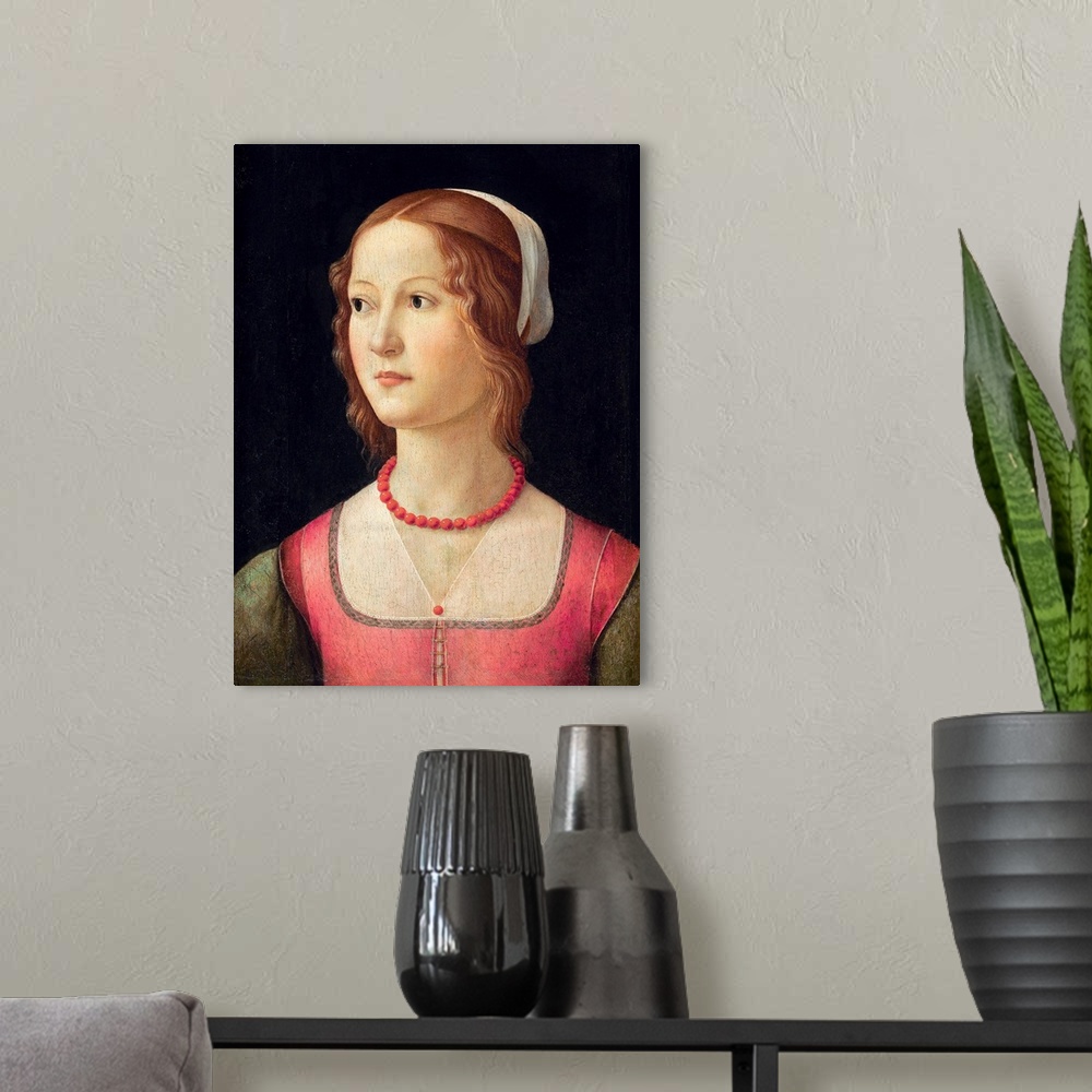 A modern room featuring Portrait of a young woman wearing a coral bead necklace. Circa 1485. Tempera on panel. 44 x 32 cm...