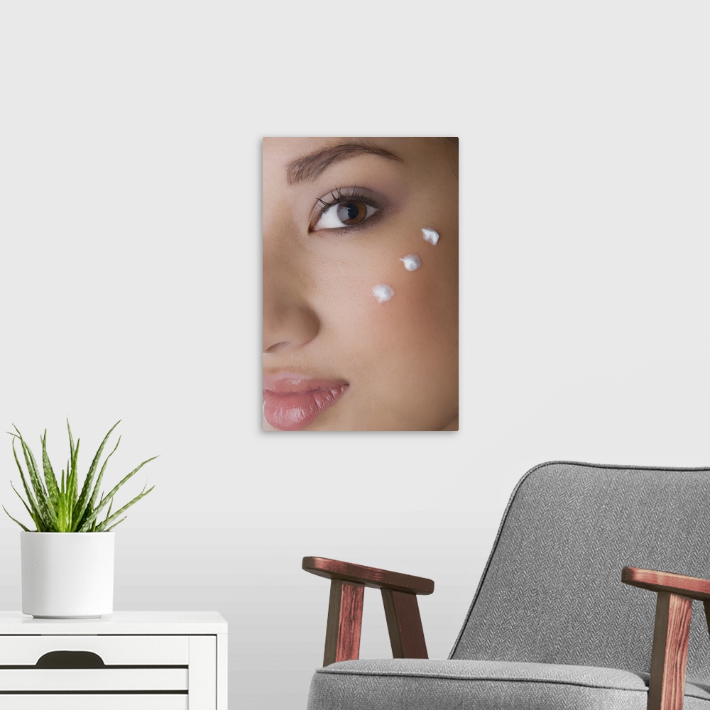 A modern room featuring Portrait of a young woman with cream on her cheek