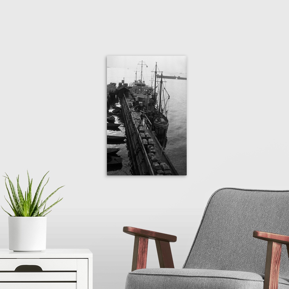 A modern room featuring 11/4/1930- New York, NY: Rum schooner gives up it cargo. Seized off Fire Island, the fishing scho...