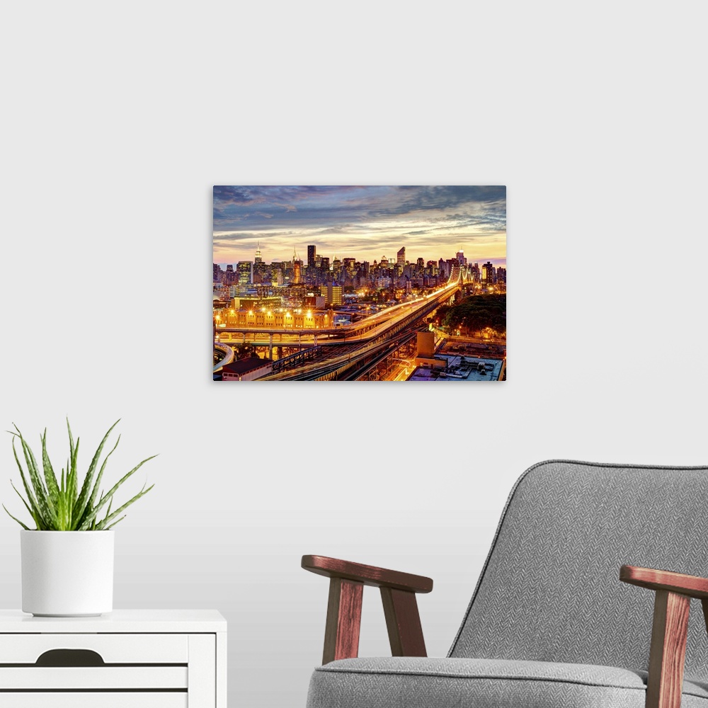A modern room featuring Queensboro Bridge and Long Island City in Queens, with Midtown Manhattan as background. Sunset ho...
