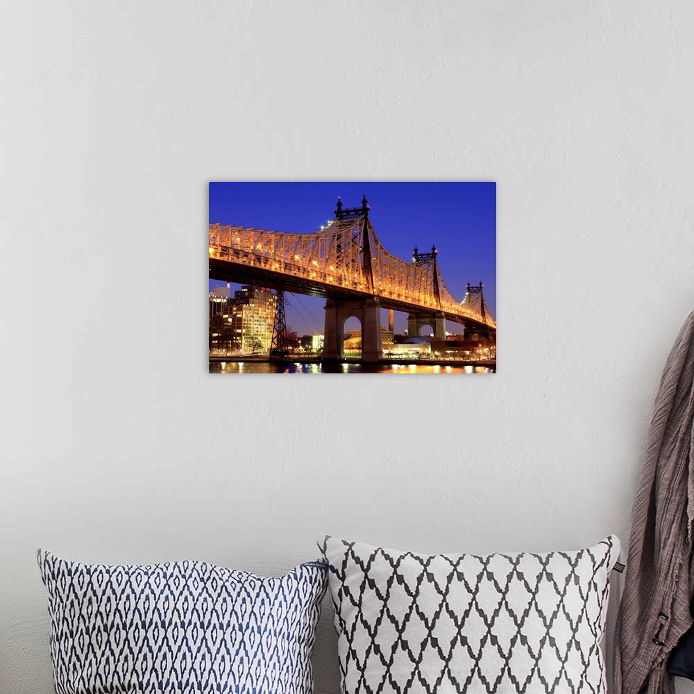 A bohemian room featuring Queensboro Bridge and the East River at night, New York.  Looking towards Roosevelt Island.