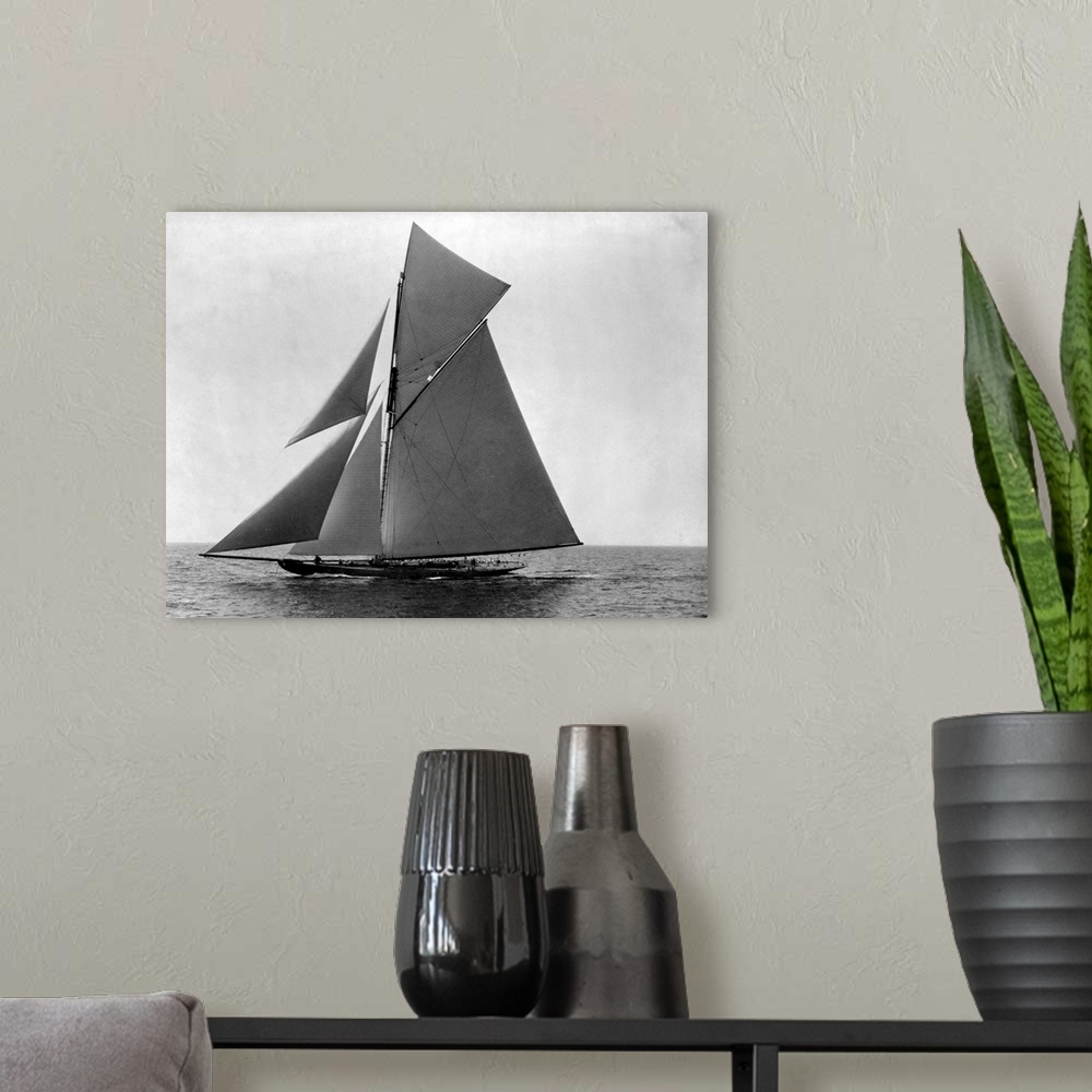 A modern room featuring The fully rigged sloop Shamrock sails in the Atlantic off New England.