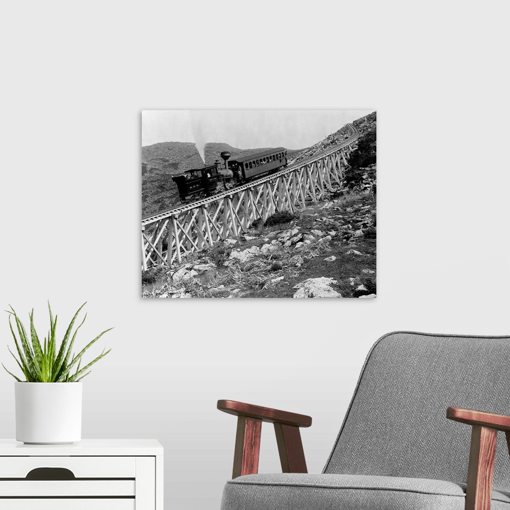 A modern room featuring A locomotive pushes a passenger car up Jacob's Ladder, a steep railroad bridge on Mount Washingto...