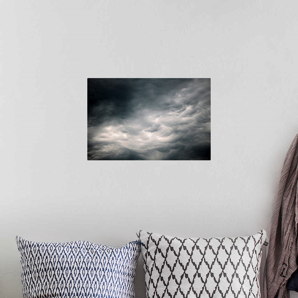 A bohemian room featuring Photograph of dark, ominous rain clouds in the sky.