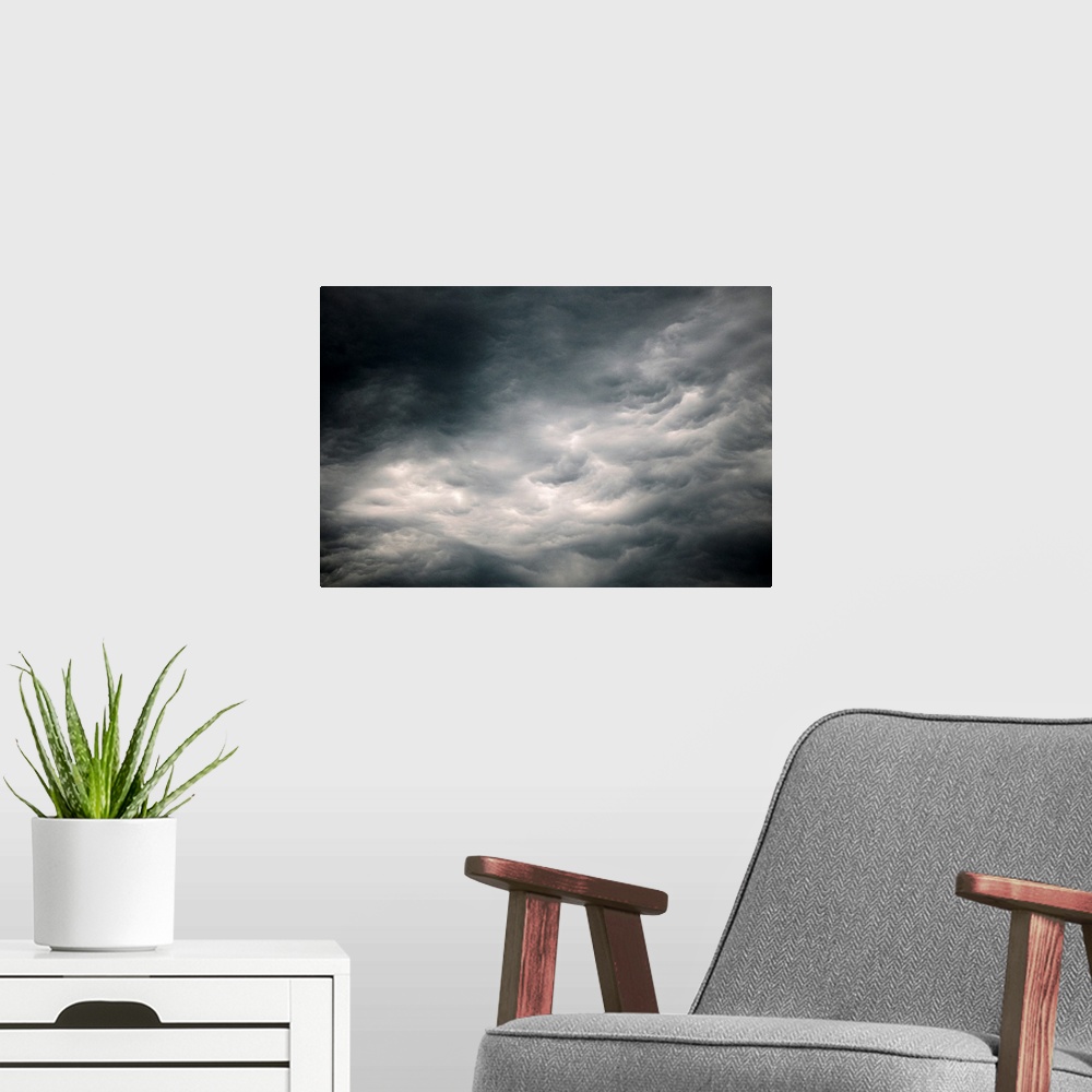 A modern room featuring Photograph of dark, ominous rain clouds in the sky.