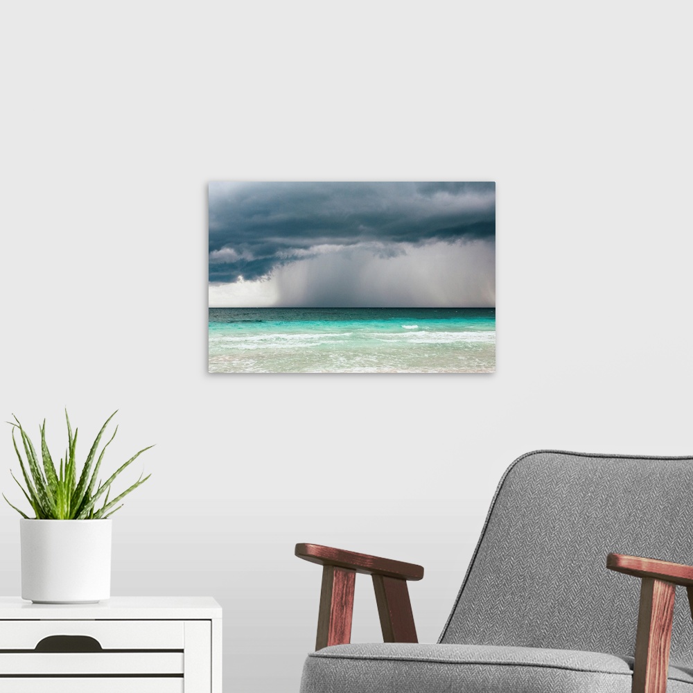 A modern room featuring Rain storm over the ocean and beach