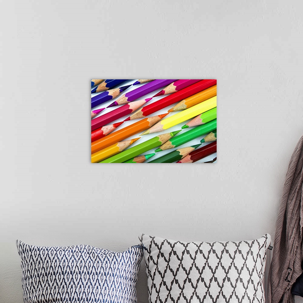 A bohemian room featuring Rainbow colored pencils arranged tip to tip.