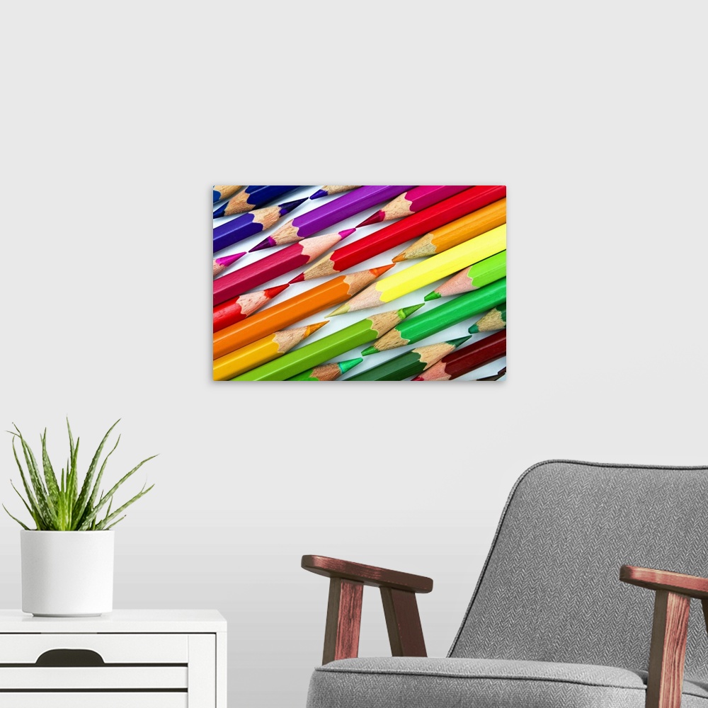A modern room featuring Rainbow colored pencils arranged tip to tip.
