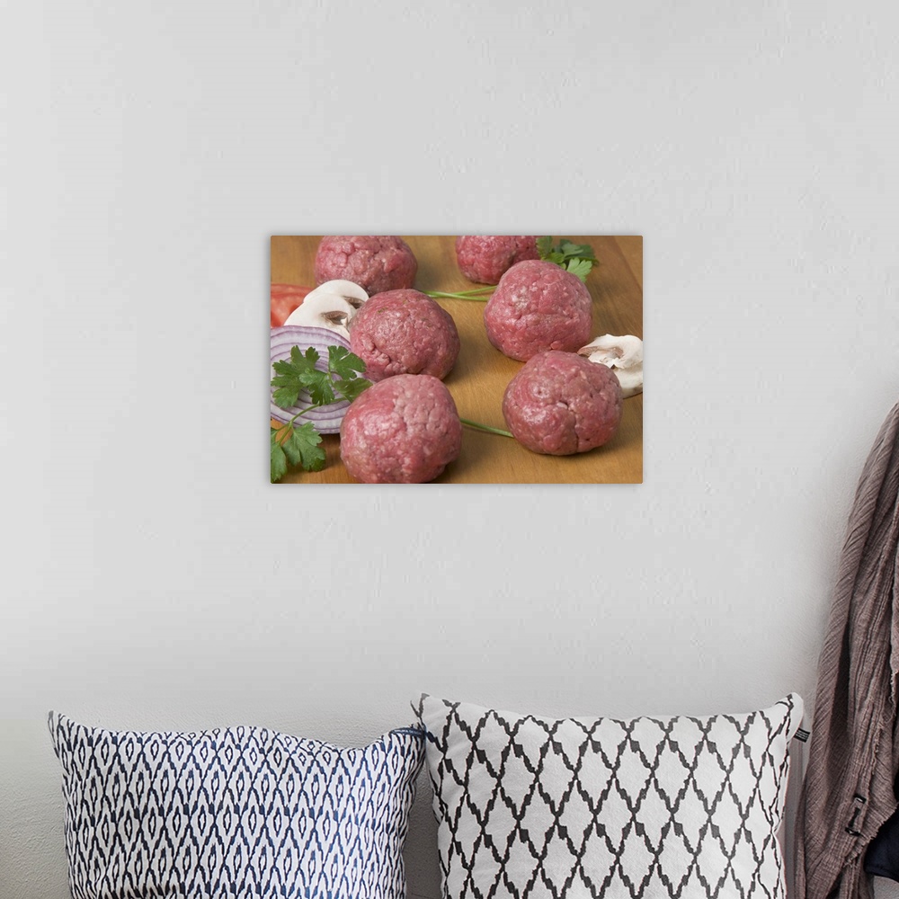 A bohemian room featuring Raw meatballs on a cutting board
