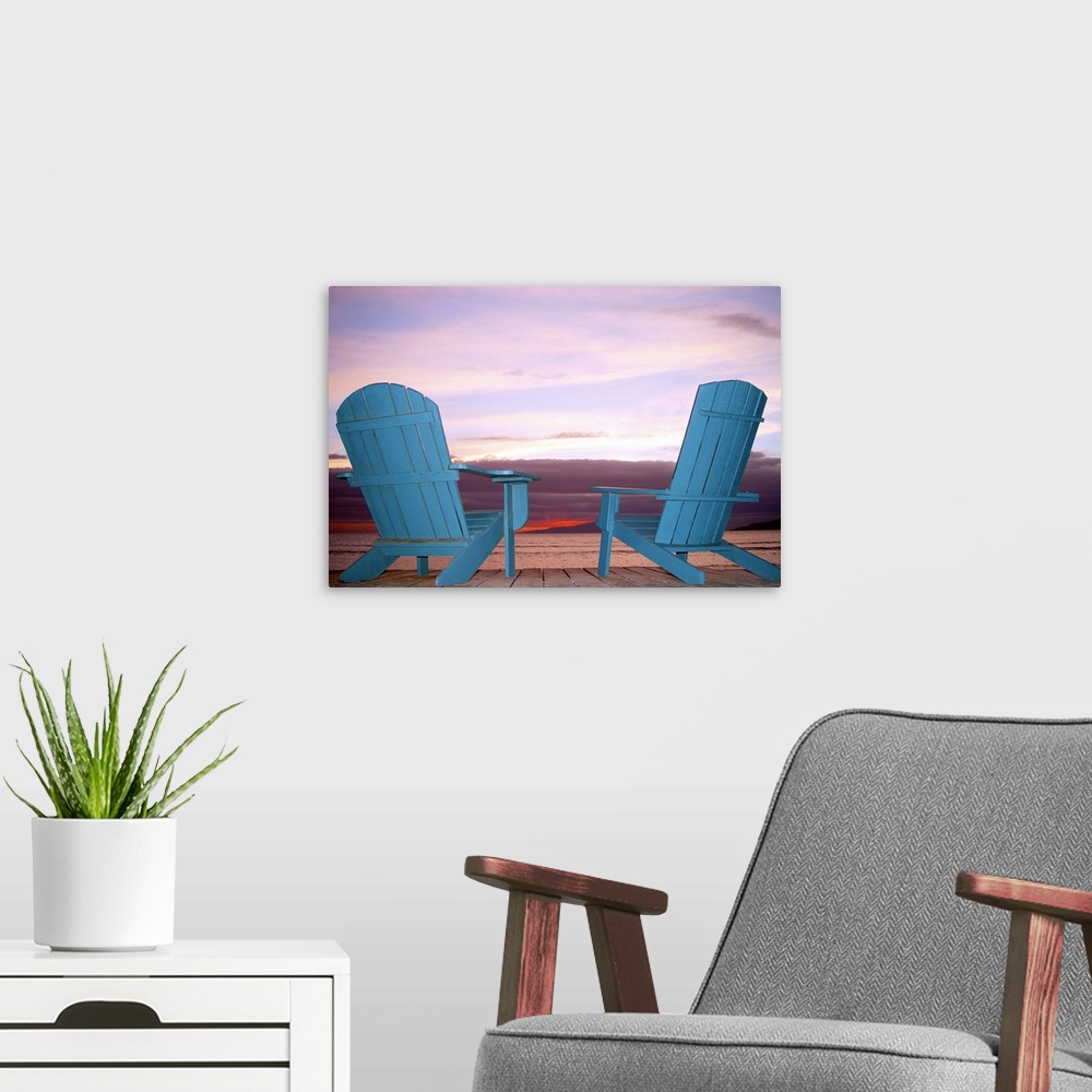 A modern room featuring Rear view still life of two blue Adirondack chairs on a boardwalk at the coast.